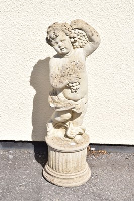 Lot 795 - Composite stone garden statue of a cherub holding grapes