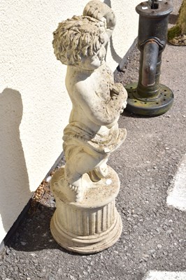 Lot 795 - Composite stone garden statue of a cherub holding grapes