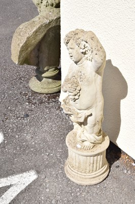 Lot 795 - Composite stone garden statue of a cherub holding grapes