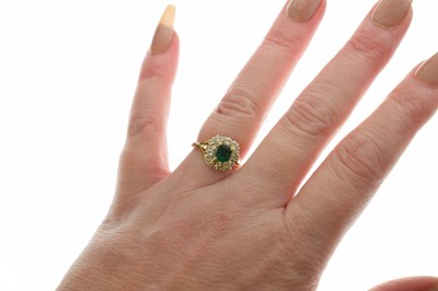 Lot 19 - Unmarked yellow metal, emerald and diamond cluster ring