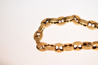 Lot 48 - Victorian unmarked gold engraved mariner link bracelet with garnet carbuncle heart locket