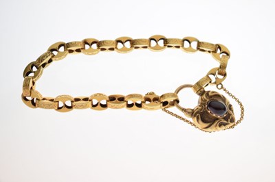 Lot 48 - Victorian unmarked gold engraved mariner link bracelet with garnet carbuncle heart locket