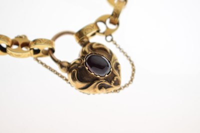 Lot 48 - Victorian unmarked gold engraved mariner link bracelet with garnet carbuncle heart locket