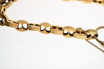Lot 48 - Victorian unmarked gold engraved mariner link bracelet with garnet carbuncle heart locket