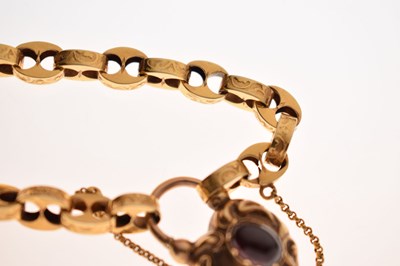 Lot 48 - Victorian unmarked gold engraved mariner link bracelet with garnet carbuncle heart locket