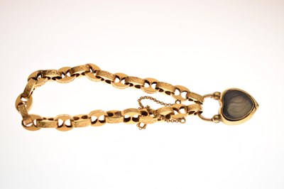 Lot 48 - Victorian unmarked gold engraved mariner link bracelet with garnet carbuncle heart locket