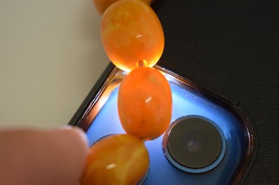 Lot 37 - String of graduated oval butterscotch amber beads