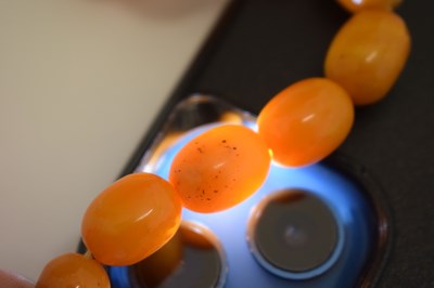 Lot 37 - String of graduated oval butterscotch amber beads