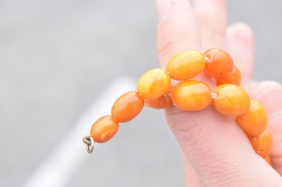 Lot 37 - String of graduated oval butterscotch amber beads
