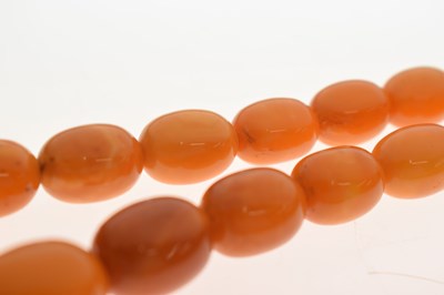 Lot 37 - String of graduated oval butterscotch amber beads