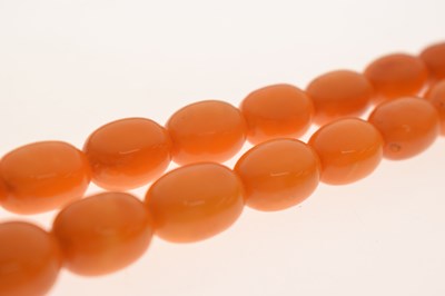 Lot 37 - String of graduated oval butterscotch amber beads