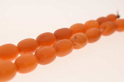 Lot 37 - String of graduated oval butterscotch amber beads