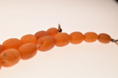 Lot 37 - String of graduated oval butterscotch amber beads