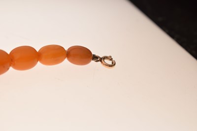Lot 37 - String of graduated oval butterscotch amber beads