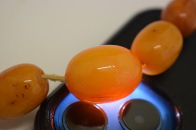 Lot 37 - String of graduated oval butterscotch amber beads