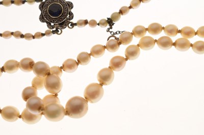 Lot 43 - Edwardian graduated pearl double string necklace with sapphire set clasp