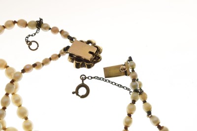 Lot 43 - Edwardian graduated pearl double string necklace with sapphire set clasp