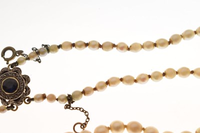 Lot 43 - Edwardian graduated pearl double string necklace with sapphire set clasp