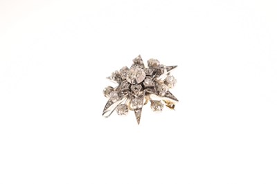 Lot 18 - Early 20th century diamond yellow and white metal starburst pendant brooch