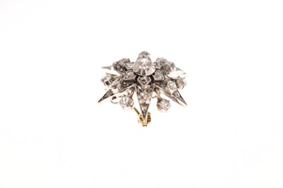 Lot 18 - Early 20th century diamond yellow and white metal starburst pendant brooch