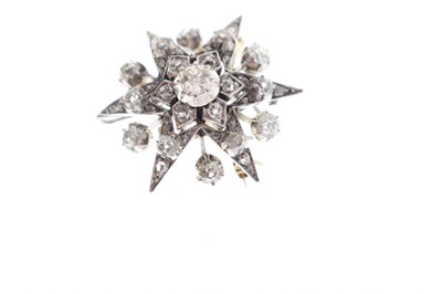 Lot 18 - Early 20th century diamond yellow and white metal starburst pendant brooch