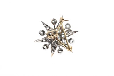 Lot 18 - Early 20th century diamond yellow and white metal starburst pendant brooch