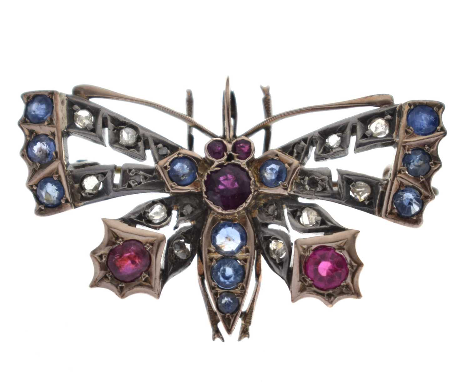 Lot Diamond, ruby and sapphire yellow and white metal set pendant brooch in the form of a butterfly