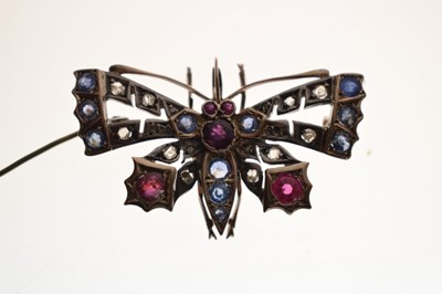Lot Diamond, ruby and sapphire yellow and white metal set pendant brooch in the form of a butterfly