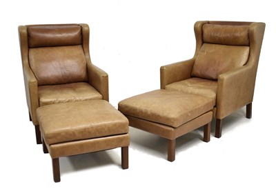 Lot 496 - Pair of tan leather club style wing armchairs and footstools