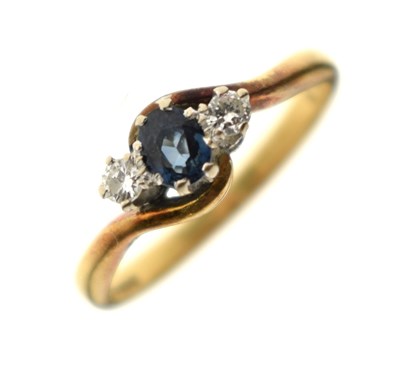 Lot 48 - Sapphire and diamond three-stone crossover 18ct gold ring