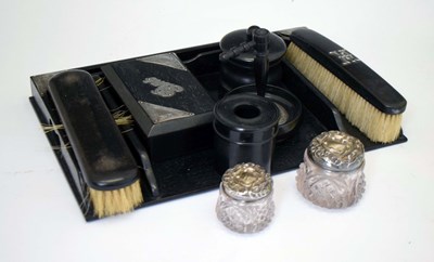 Lot 255 - Ebonised silver mounted dressing table set, two cut glass and silver topped pots