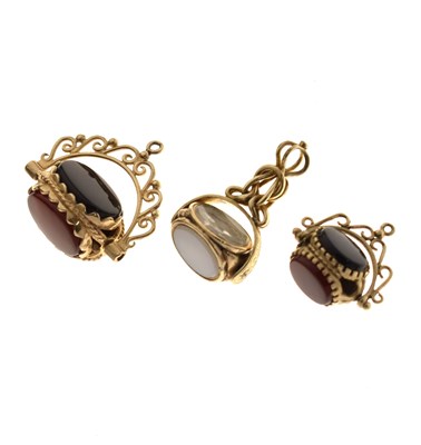 Lot 192 - Three hardstone yellow metal swivel fobs