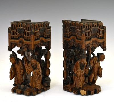 Lot 354 - Pair of Chinese carved softwood figural furniture stands